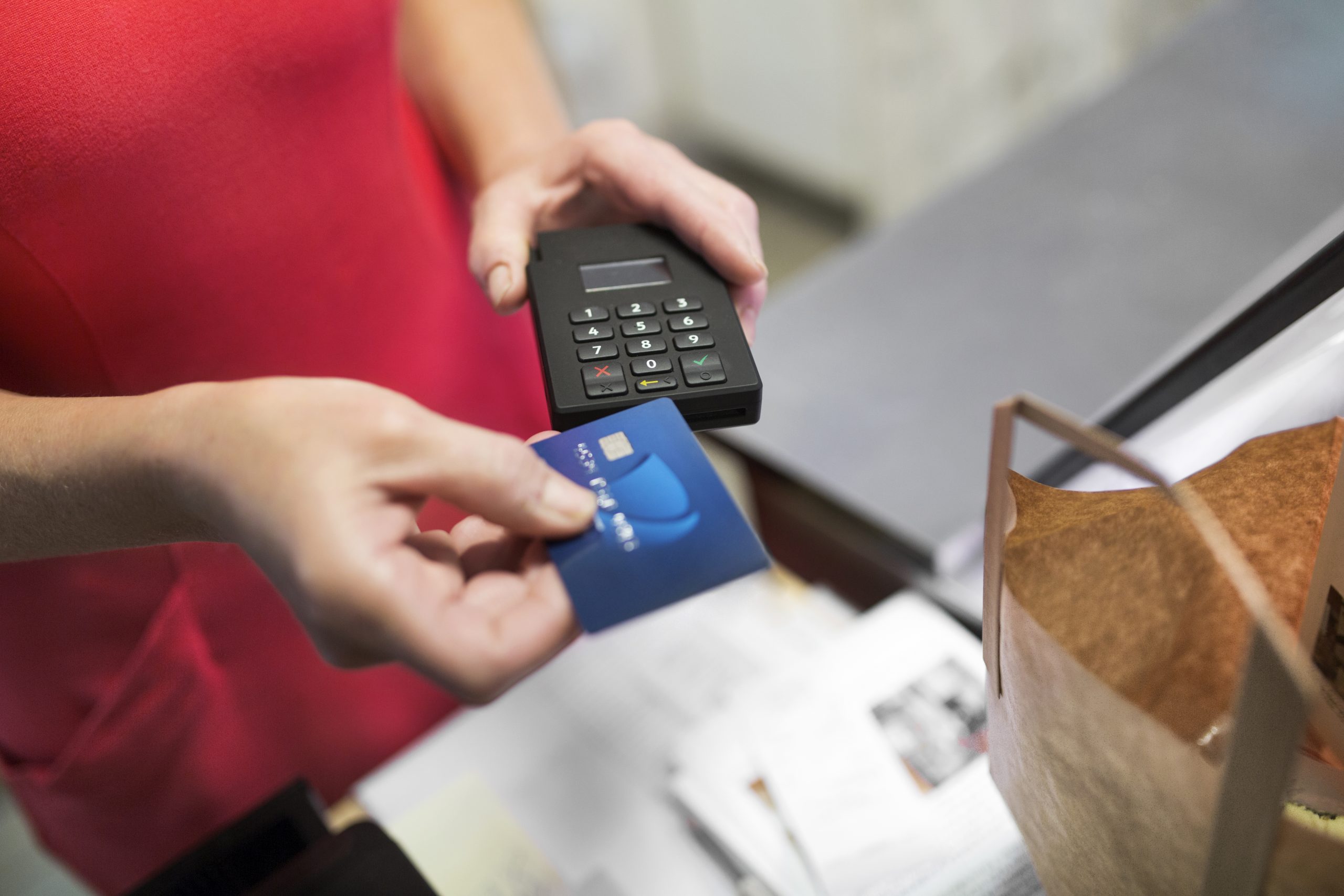 close-up-of-sales-clerk-putting-credit-card-in-cre-RDLMF7F-scaled