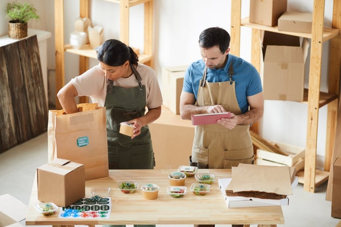 workers-packaging-orders-at-food-delivery-service-AUEXWP6